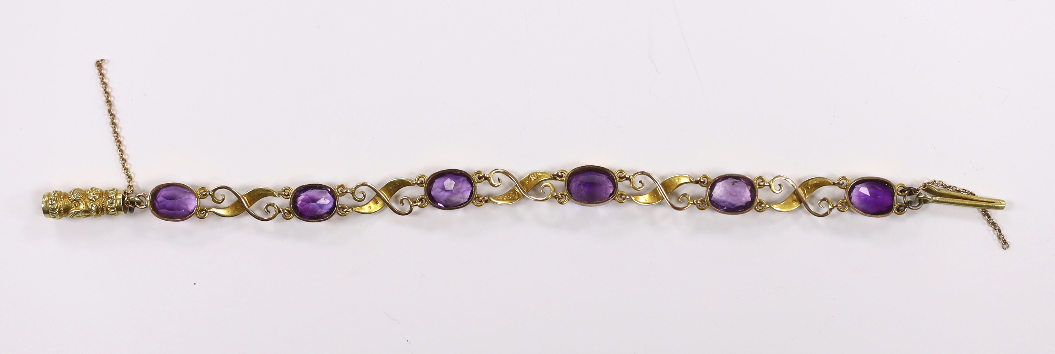 An early 20th century 9ct, amethyst and seed pearl cluster set bracelet, with carved barrel shaped clasp, approx. 16cm gross weight 8.4 grams.